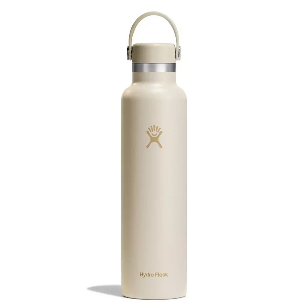 pastel beige Hydro Flask bottle with tonal dark beige/tan "Hydro Flask" wordmark and logo; matching lid with a top carry handle