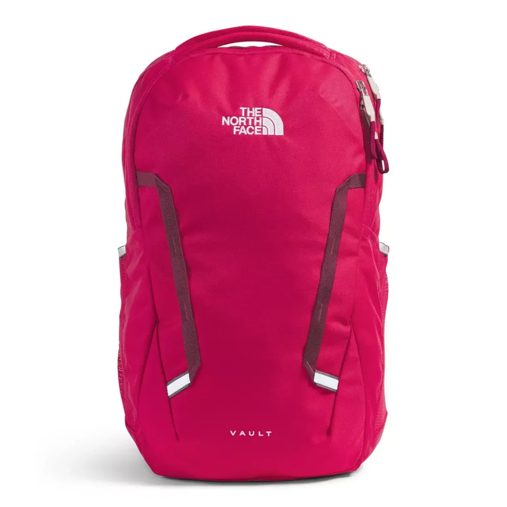 red/dark pink The North Face backpack with zippered main compartments, a top carry handle and contrast white "VAULT" branding, along with a contrast white The North Face half dome logo towards the top