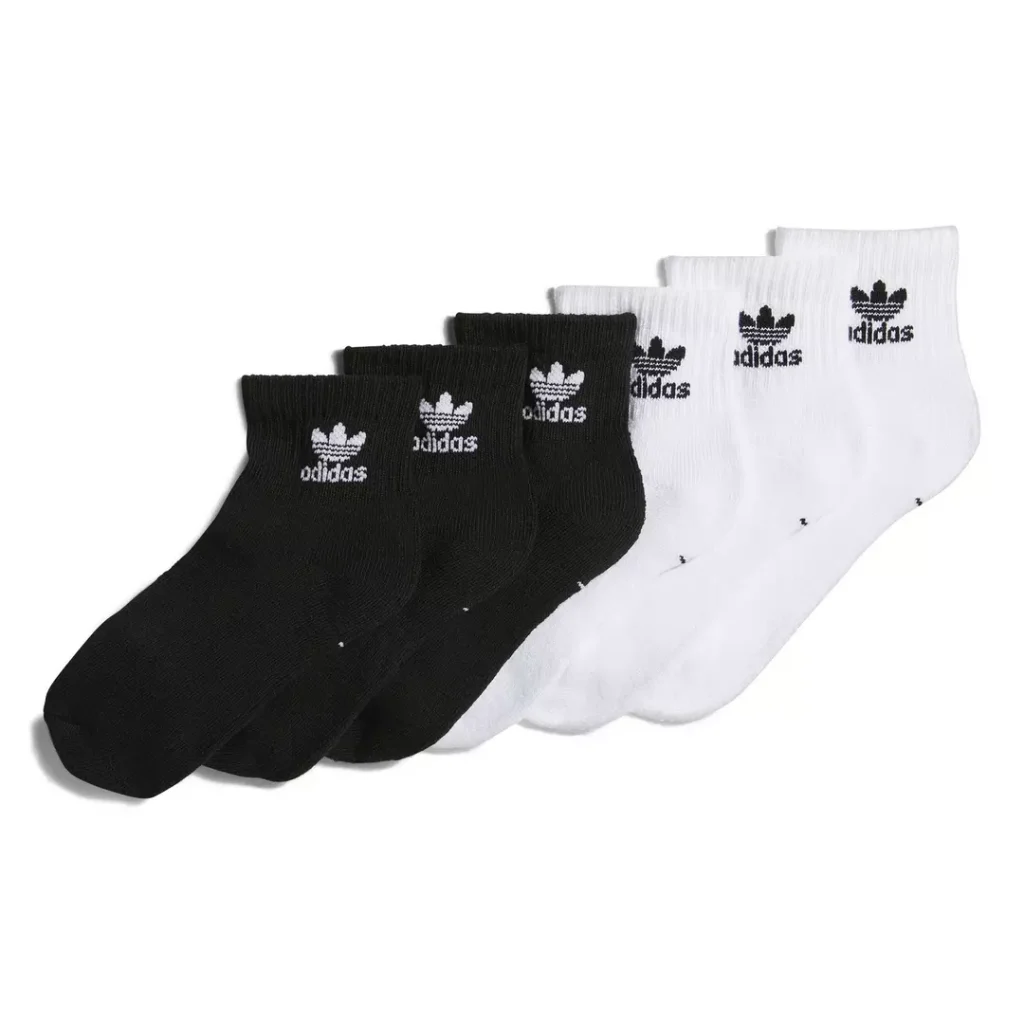 6 pack of adidas Originals ankle socks with 3 white pairs that feature contrast black Trefoil logos and "adidas" wordmarks, plus 3 black pairs that feature contrast white Trefoil logos and "adidas" wordmarks