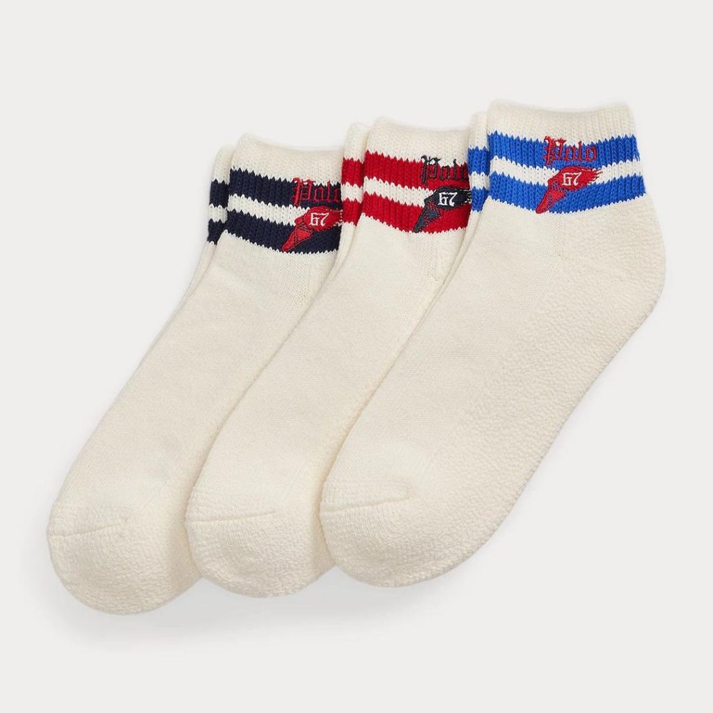 3 pairs of white Polo Ralph Lauren socks with contrast two contrast stripes at the cuffs and Polo branding with a winged shoe graphic