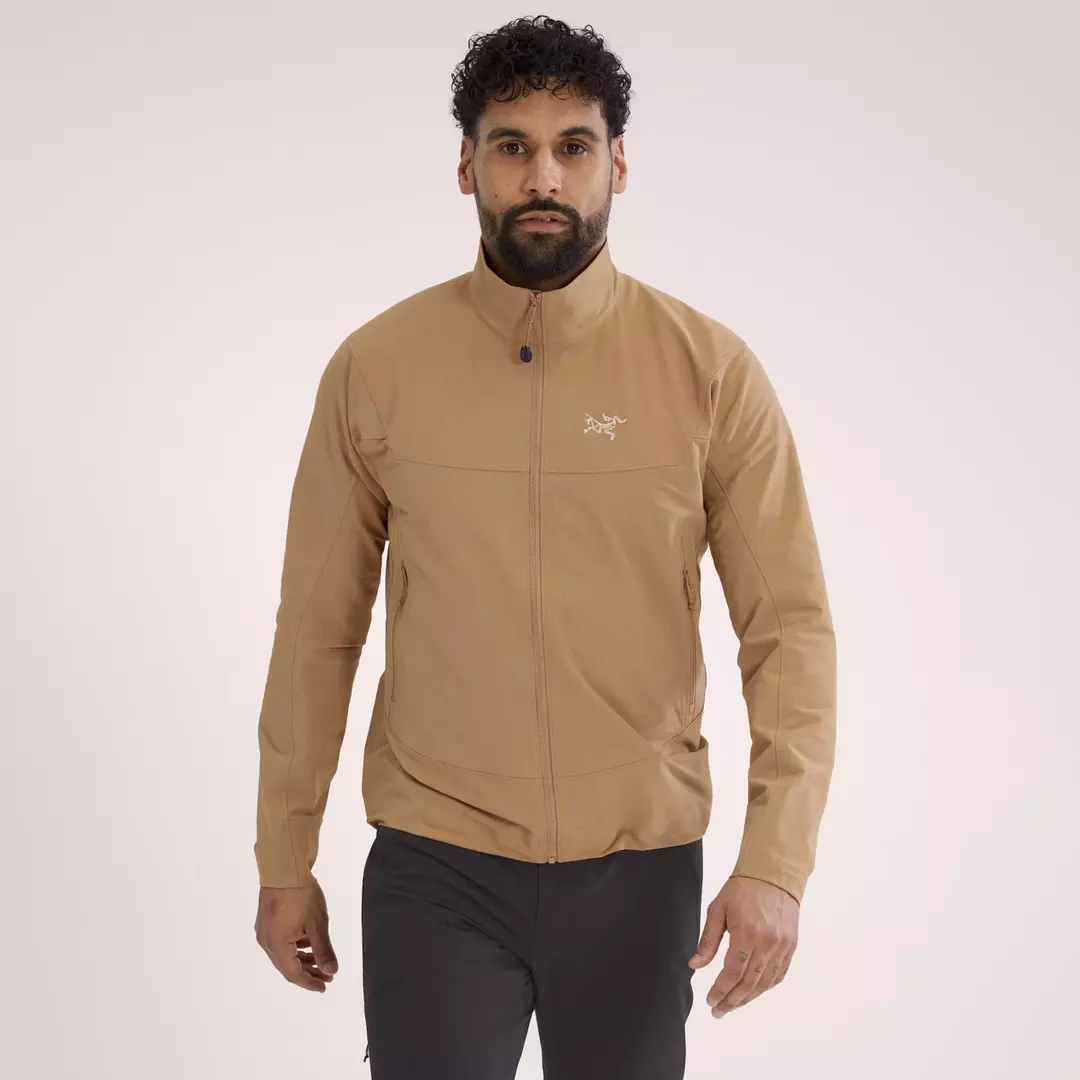 khaki softshell Arc'teryx jacket with logo at left chest